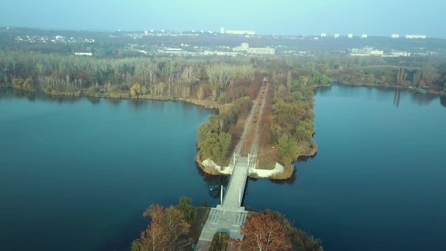 Aerial footage over Echo Park Lake, Kishinev, Moldova republic of. View of lake and smille bridge.