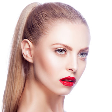 Attractive girl with bright red lips, blue eyes make-up, blonde hair. White background. Copy space