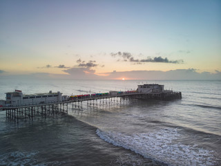 Drone aerial view landscape image of Worthing pier on Sussex coast in England at dawn
