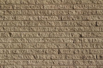 Rough textured tan brown stone brick wall abstract background