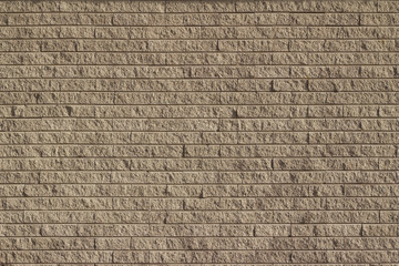 Rough textured tan brown stone brick wall abstract background