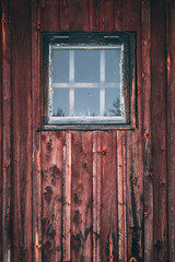 Old window on an old cabin wooden wall