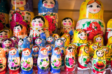 Dolls, Matryoshka Doll, in Gift Shop Shelf. Colorful Set of Various Wooden Stacking Women Figure Dolls in Traditional Old Russian Clothes.