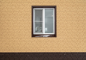 Window in a new brick house as a background