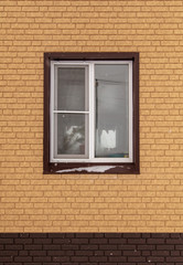 Fototapeta na wymiar Window in a new brick house as a background