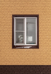 Window in a new brick house as a background