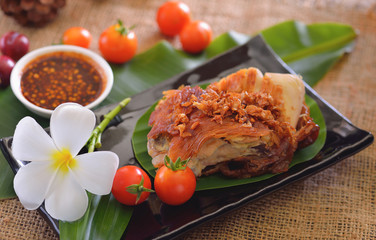 Grilled chicken with fresh vegetables. Baked chicken meat with tomatoes cherry. Homemade meat on wooden table.