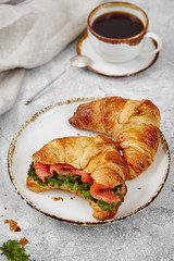 breakfast from croissant with fish and salad