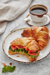 breakfast from croissant with fish and salad