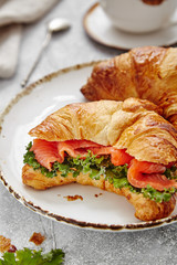 breakfast from croissant with fish and salad