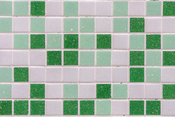 abstract square pixel mosaic wall background and texture. Green glass mosaic tile background pattern.