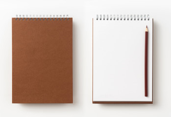 Top view of brown spiral notebook, page, pencil