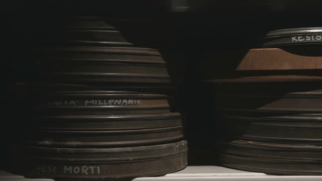 Film can on a shelf in historical archive tracking shot