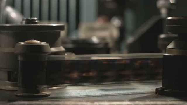 Film reel close up pan rolling in old film editing equipment