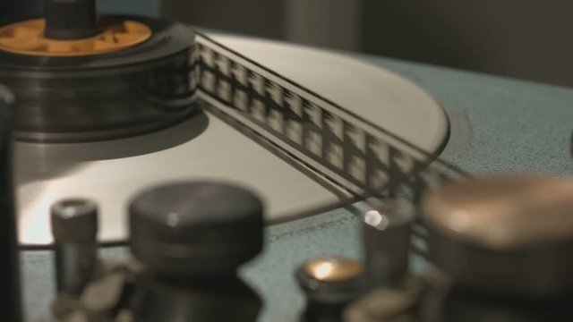 Film rolling reel in old film editing equipment start and stop