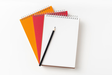 Top view of 3 spiral notebook, page, pencil