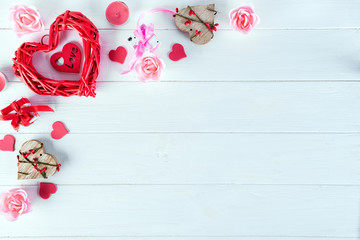 Wooden white background with red hearts, gifts and candles. The concept of Valentine Day, flat lay copy space
