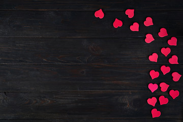 Wooden dark Background with Decorative red hearts for design to Valentine's Day. View from above. Valentines Day concept