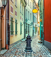 Winter in narrow medieval street of old Riga - the capital and largest city of Latvia, a major...