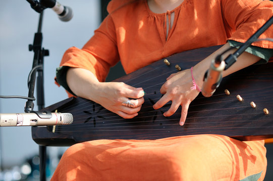 Woman&rsquo;s hands playing Latvian national musical instrument cockle (psaltery)
