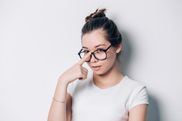 Portrait of young beautiful brunette woman with glasses on white background