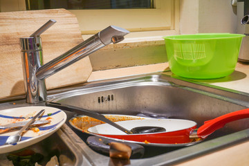 Dirty Kitchen Sink and Utensils Need a Wash