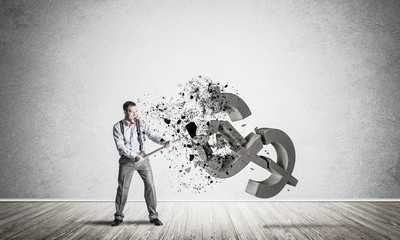 Determined banker man in empty concrete room breaking dollar fig