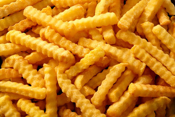 Close up background of crinkle cut fried chips