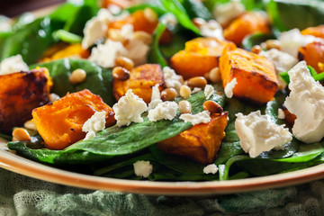 Roasted pumpkin salad with spinach and nuts