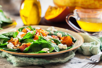 Roasted pumpkin salad with spinach and nuts