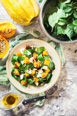 Roasted pumpkin salad with spinach and nuts