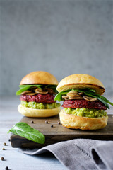  Homemade Beetroot quinoa burger combined with avocado sauce and mashrooms. Healthy vegetarian food