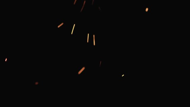 Slow motion hot sparks falling from above black background, 180fps