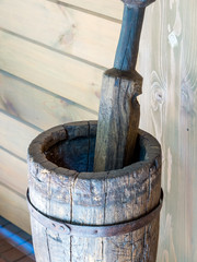 An old wooden stupa with a wooden pestle in it