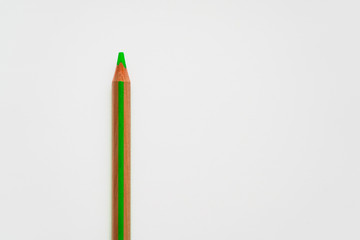 green wooden pencil on white background