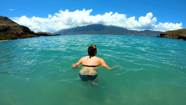 Female on a deserted Island beach Tahuata Marquesas