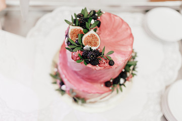 Obraz na płótnie Canvas wedding cake with flowers and fresh berries