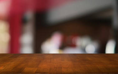 Empty dark wooden table in front of abstract blurred bokeh background of restaurant . can be used for display or montage your products.Mock up for space.