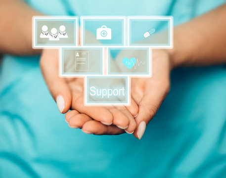 Concept of medical support and care. Doctor holding virtual blocks with medical icons.