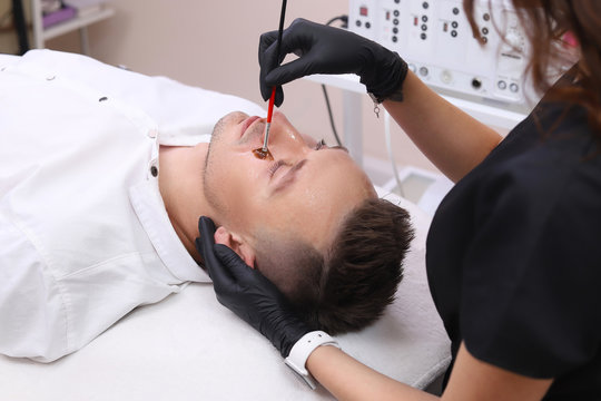 Cleaning the face of a man in a beauty salon.