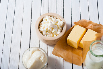 homemade dairy product samples on white wood table background