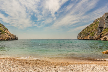 View from the beach to the sea with rocks.