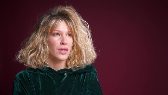 Closeup portrait of young attractive caucasian female with blond hair looking on the side front view