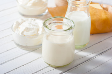 dairy product samples on white wood table background