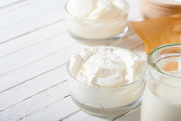 dairy product samples on white wood table background