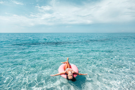 Child on lilo relaxing on the beach