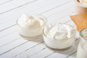 yogurt and creme fraiche on white wooden table background