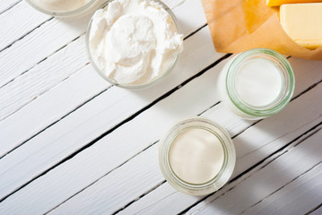Fototapeta na wymiar homemade dairy product samples on white wood table background