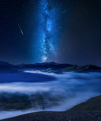 Milky way over foggy valley in Umbria, Italy