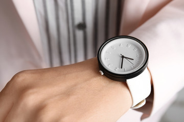 Businesswoman with stylish wrist watch, closeup. Time management